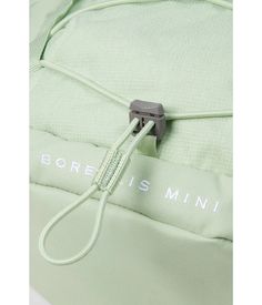 the back side of a green backpack with an electric cord attached to it's front pocket