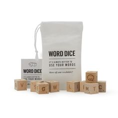 the word dice game is set up in front of a white bag and wooden blocks