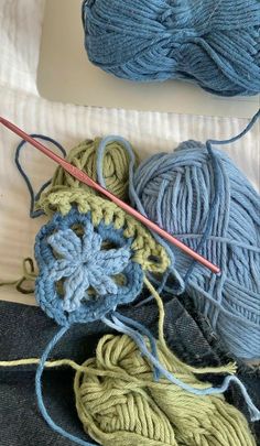 two balls of yarn and a crochet hook