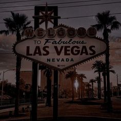 the welcome to fabulous las vegas sign in front of some palm trees and power lines