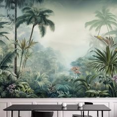 a dining room table and chairs with a mural on the wall behind it that features tropical trees