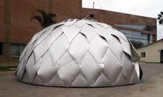 a large metal object sitting in front of a building