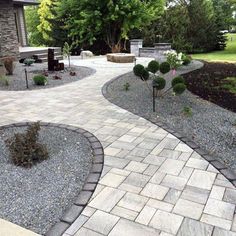 a stone walkway in the middle of a garden