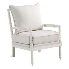 a white chair with buttons on the armrests and a pillow in front of it