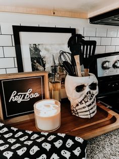 a kitchen counter topped with a skull mask next to a candle