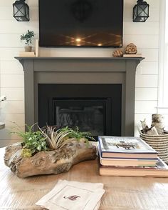 a living room filled with furniture and a flat screen tv mounted above a fire place