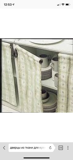 an open cabinet with plates and cups in it