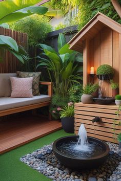 a small garden with a fountain and seating area