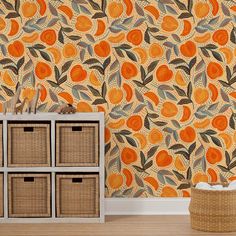 an orange and brown wallpaper with leaves on it in a room next to baskets