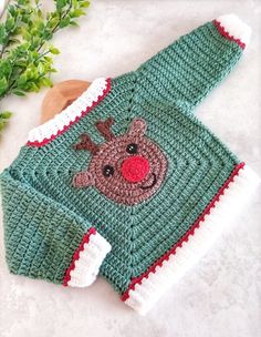 a crocheted sweater with a reindeer on it