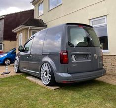 a grey van parked in front of a house