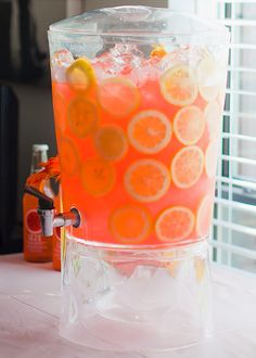 a pitcher filled with orange slices and ice