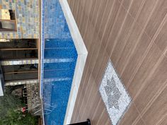 an aerial view of a pool and tiled walls