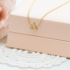 "Delicate Magen David Charm gold necklace, A Star of David necklace, a symbol of Jewish faith and heritage, a beautiful piece of Israeli Jewelry. This meaningful Magen David pendant necklace represents the enduring strength and spirit of the Jewish people. The 'Magen David' is an iconic symbol of Judaism, signifying its significance and unity. This necklace is not only a stunning piece of jewelry but also a timeless gift that holds deep meaning for those you cherish. MAGEN DAVID CHARM NECKLACE ✧ DETAILS: ✦ 14k white/yellow/rose gold. Please select your preferred choice from the drop-down menu, when ordering. ✦ The charm pendant measures 7 mm (0.26\") in diameter. ✦ The charm is 0.75 mm (0.03\" ) in thickness.  ✦ Length options :  ✧ 14 inches necklace  ✧ 16 inches chain necklace  ✧ 18 inche Star Of David Necklace, Delicate Pendant, Jewish Star, Jewelry Delicate, Jewish People, Deep Meaning, Timeless Gifts, Star Of David, Gold Star