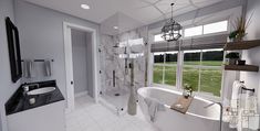 a bathroom with a large bathtub next to a walk in shower and two sinks