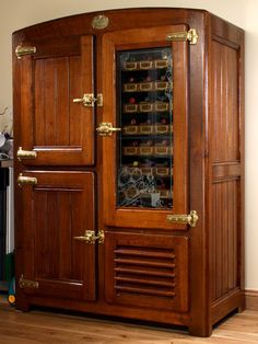 an old fashioned wooden cabinet with many items in the door and drawers on it's sides