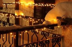 snow covered railing with lights on it