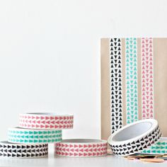 three rolls of washi tape sitting next to each other on top of a table