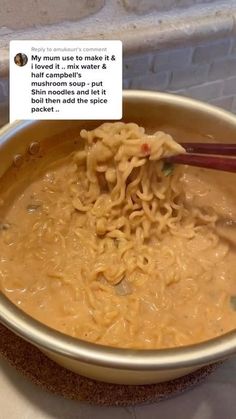 a bowl full of noodles with chopsticks sticking out of it and someone's tweeting