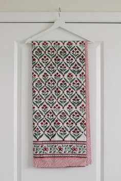 a white door with a red and green towel hanging on it