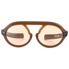 Hardly seen up for sale, " Jardin Dior " this robust frame is a true rarity since its not made from optyl, rather a sample. Lenses are spotless brown. Please notice this item its nearly 60 years old and may show minor sign of wear due to storage. This pair is a must have for a collector! a great opportunity to achieve a unique and yet timeless look Mesurements: Front : 16 cms Lens height : 4.6 cms Lens width : 5.6 cms Vintage Designer Sunglasses, Dior Glasses Sunglasses, Vintage Brown Sunglasses With Mirrored Lenses, Dior Vintage Sunglasses, Luxury Brown Vintage Cat Eye Sunglasses, Unique Eyewear, Dior Sunglasses