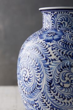 a blue and white vase sitting on top of a table