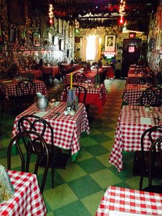 a restaurant with checkered tables and red and white tablecloths on the tables