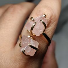 Elevate your style and gift love with our Raw Rose Quartz Ring. This exquisite piece showcases the gentle beauty of rose quartz, known for its soft pink hues and heartwarming energy. It's not just a statement piece; it's a heartfelt gift that captures the essence of affection and elegance. 🔸Adjustable band ring 🔸10 mm each stone size 🔸Color may vary according to lighting 🔸Gold filled We offer  🔸Fast shipping ( under normal conditions) 🔸Free shipping  🔸Polishing cloth ( to keep your piece shiny) 🔸Jewelry case on orders of 100€ 🔸Gift box 🎁 🔸Great customer service                                  Rose quartz is cherished for its association with love and positivity. It's believed to enhance emotional well-being and open the heart. Its gentle pink tones make it a timeless choice for Adjustable Rose Gold Crystal Ring With Birthstone, Silver Rose Quartz Crystal Ring Gift, Rose Gold Spiritual Crystal Ring For Gift, Round Rose Quartz Birthstone Jewelry, Rose Gold Birthstone Crystal Ring For Promise, Quartz Jewelry Ring Gift, Quartz Ring Jewelry For Gift, Adjustable Gemstone Jewelry For Promise, Round Rose Quartz Promise Ring