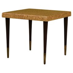 a small table with wooden legs and a cork top