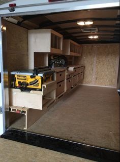 the inside of a trailer with drawers and tools in it