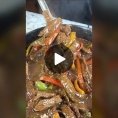 beef and peppers being cooked in a skillet