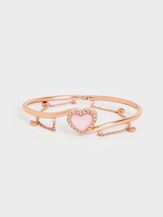 This Annalise bracelet is made for the romantics. Featuring a sweet pink heart-shaped stone that is wreathed in sparkly crystals, the result is a dainty silhouette that will sit prettily on the wrist. Dangly chain links and heart charms enhance the feminine charm of the bracelet, making it a beautiful piece to wear for date nights and elevated occasions. Due to the nature of semi-precious stones, the actual product received may vary from the product images shown on the website. Colours may appea Sparkly Crystals, The Romantics, Chain Links, Charles Keith, Stone Heart, Semi Precious Stones, Cuff Bangles, Crystal Heart, Product Images