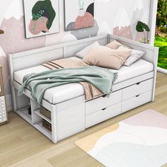 a white bed sitting in a bedroom next to a dresser and lamp on top of a hard wood floor