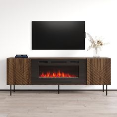 an entertainment center with a fireplace in the middle and a flat screen tv above it