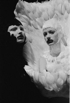 two people with white feathers on their heads