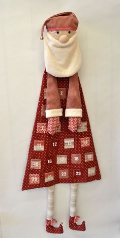 a doll is dressed in red and white