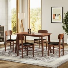 a dining room table and chairs with a rug on the floor in front of it