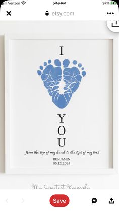 a white frame with a blue handprint in the shape of a baby's foot