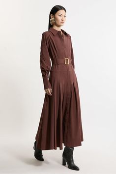 Feel Polished In Our Shirt Maxi Dress Featuring A Tailored Bodice And Pleated, Flowing Skirt. The Stylish Belted Detail Accentuates The Waist, Creating A Flattering Silhouette That Complements Every Body Type. This Maxi Dress Is An Ideal Choice For An Elevated Work Outfit And Allows You To Seamlessly Transition From Desk To Dinner With Sophistication. Formal Tailored Belted A-Line Maxi Dress Flattering Tailored Bodice Elegant Pleated Skirt Belted Detail Statement Strong Shoulders Drop Waistline Formal Brown Belted Dress, Maxi Length Belted Shirt Dress For Work, Belted Maxi Shirt Dress For Work, Belted Brown Dress For Work, Elegant Brown Maxi Dress For Work, Formal Brown Long Sleeve Maxi Dress, Elegant Long Sleeve Brown Shirt Dress, Elegant Brown Shirt Dress For Daywear, Collared Brown Dress For Work