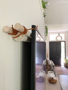 a pair of slippers hanging on the side of a wall next to a door