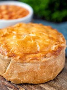 a pot pie sitting on top of a wooden cutting board