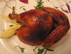 a roasted chicken on a plate with parsley