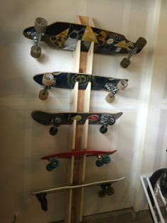 several skateboards mounted to the side of a wall