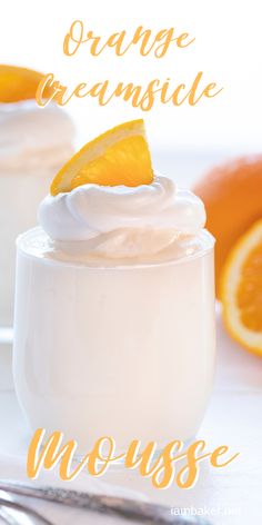 orange creamsice mousse in a glass with an orange slice on top