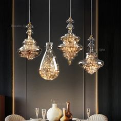 three lights hanging over a dining room table