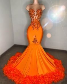 Show-stopping mermaid gown in a vibrant orange hue Intricate beadwork and embellishments adorn the sheer bodice for a dazzling effect Form-fitting silhouette that flares into a dramatic train Feather accents along the hemline add a touch of whimsy and elegance Ideal for prom, galas, and other glamorous events Made with premium fabrics to ensure comfort and durability Available in various sizes for a perfect fit Orange Prom Dresses For Sale, Plus Size Orange Prom Dresses, Orange Masquerade Dress, Neon Orange Dress Prom, Orange Sweet 16 Dresses, Orange And Silver Prom Dress, Orange And Gold Prom Dress, Orange Dresses Prom, Orange Prom Dresses Long