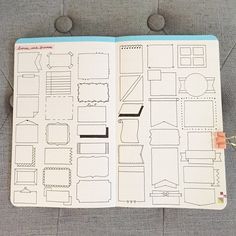 an open notebook with cut outs on the pages and some paper clips attached to it