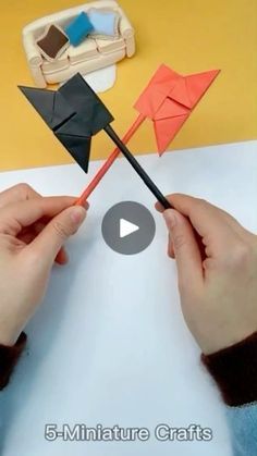 someone is making an origami boat out of paper