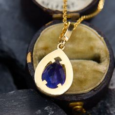 This deeply saturated gemstone pendant is centered with a pear cut tanzanite, weighing 2.36 carats, in a four-prong setting. The tanzanite is surrounded by a halo that is shared prong set with twenty-four (24) round brilliant cut diamonds. The bail is shared prong set with six (6) round brilliant cut diamonds. The pendant measures 24.3mm long, including the bail, by 10.7mm wide and 5.2mm deep. We have added an 18 inch long cable chain, with jump rings so it can be worn at 16 or 17 inches as well Teardrop Tanzanite Jewelry In Yellow Gold, Formal Tanzanite Teardrop Jewelry, Tanzanite Teardrop Gemstone Jewelry, Teardrop Tanzanite Gemstone Jewelry, Tanzanite Diamond, Halo Pendant, Diamond Halo, Pear Cut, Round Brilliant Cut Diamond