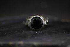 "Archangel ring. // Black onyx, sterling silver. Features the sigils of the archangels Raphael, Michael, Gabriel, and Uriel, set with a 12mm black onyx. The word archangel derives from the Greek ἀρχάγγελος, meaning \"chief angel\", or \"angel of origin.\" The archangel Michael appears in the Bible depicted as having \"the voice of the archangel, with the trumpet call of God\" and is referred to as one of the \"chief princes\". Personified as angels to man, they are the first executors of the div Formal Black Hand Forged Jewelry, Formal Hand Forged Black Jewelry, Mystical Black Sterling Silver Rings, Black Sterling Silver Hand Forged Jewelry, Black Hand Forged Sterling Silver Jewelry, Minimalist Hand Forged Black Rings, Hand Forged Black Sterling Silver Jewelry, Hand Forged Black Rings, Archangels Raphael